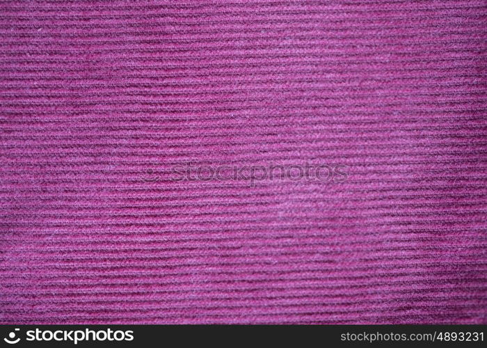 textile and texture concept - close up of purple velveteen fabric background. close up of purple textile or fabric background