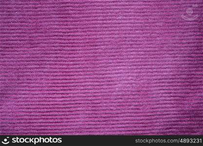 textile and texture concept - close up of purple velveteen fabric background. close up of purple textile or fabric background