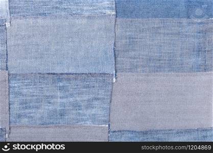 textile background - patchwork from denim flaps. patchwork from denim flaps