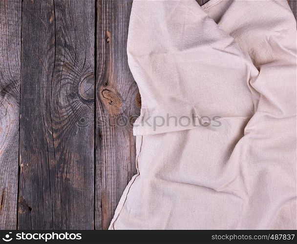 textile dishcloth on a gray wooden background from old boards, copy space