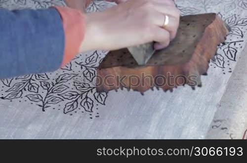 Textile distempering with stamp in a traditional style. Clip 2