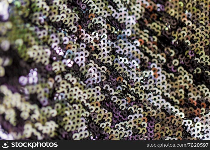 textile, party and texture concept - shimmering fabric with sequins background. shimmering fabric with sequins background