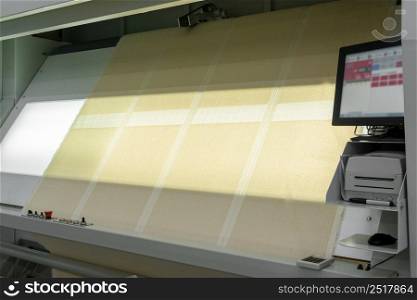 textile products and fabric in slides on lamp backlit screen. quality control of textiles