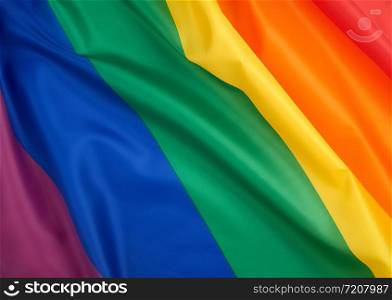 textile rainbow flag with waves, symbol of freedom of choice of lesbians, gays, bisexuals and transgender people, LGBT culture