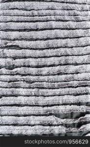 textile vertical background - surface of cloth stitched from carved fabric