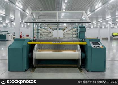 textile yarn on the wrapping machine is screwed on the big shaft. machinery and equipment in a textile factory. textile yarn processing shop