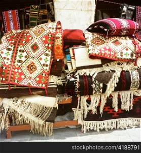 Textiles in traditional Arabian colours and designs on sale in Souq Waqif, Doha, Qatar.