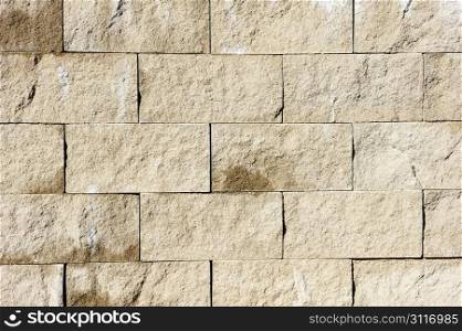 Texture - a wall of rough rectangular gray stones.