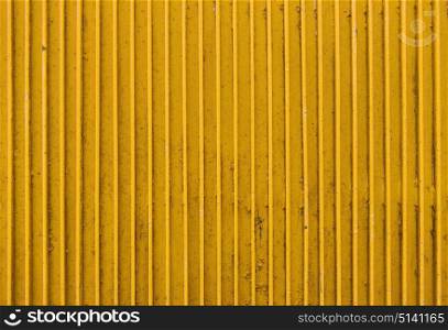 texture and background concept - old yellow painted metal ribbed surface. old yellow painted metal ribbed surface