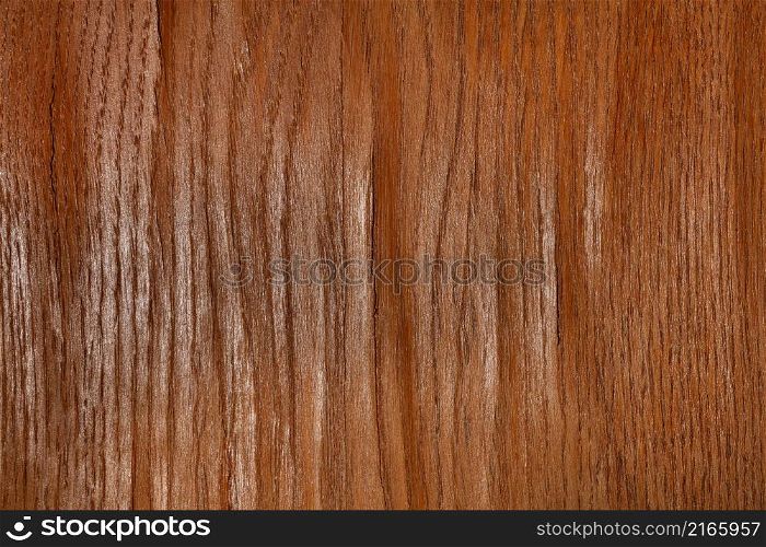 Texture and background of brown oak wood veneer with bumps and cracks. Close-up.. Texture of wood veneer with bulges and cracks.