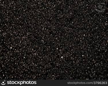 Texture black synthetic porous sponges as background