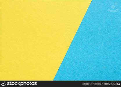 texture heavy paper, abstract yellow and blue background, divided diagonally. texture heavy paper, abstract yellow and blue background