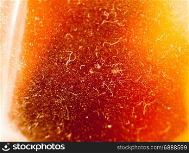 texture of a beer in a bottle from the side close up with plenty of dust and hairs