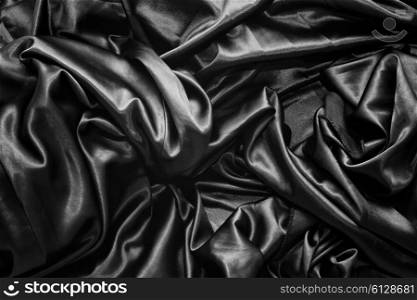 Texture of a black satin silk closeup