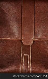Texture of a brown leather with seams close up