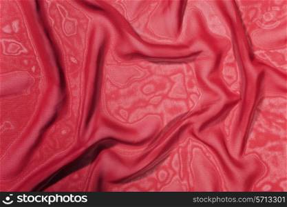 Texture of a dark red satin silk close up