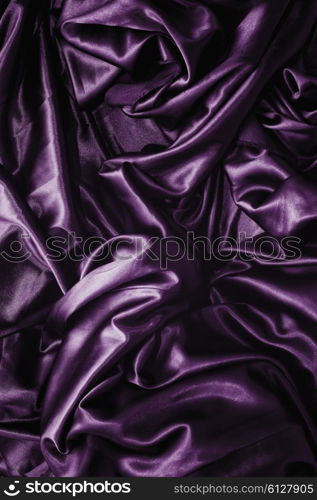 Texture of a purple satin silk closeup