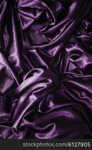 Texture of a purple satin silk closeup