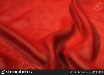 Texture of a red silk extreme closeup