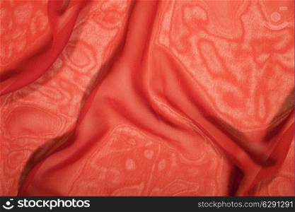 Texture of a red silk extreme closeup