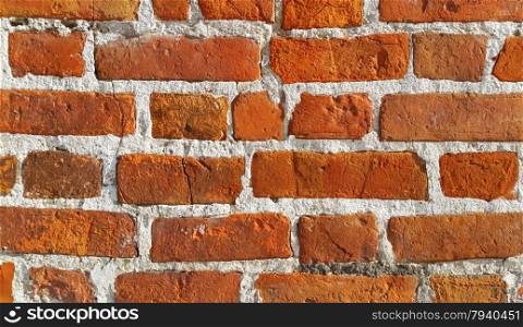 Texture of ancient red brick wall closeup