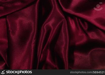 Texture of burgundy satin silk close up