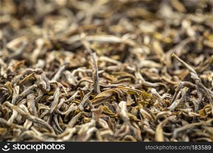 texture of Chinese oolong black tea, macro image of loose leaves with a selective focus