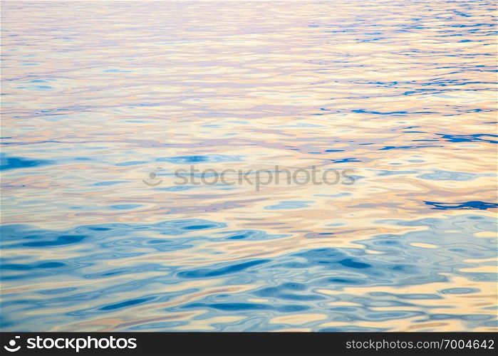 Texture of colorful water surface at sundown - natural background