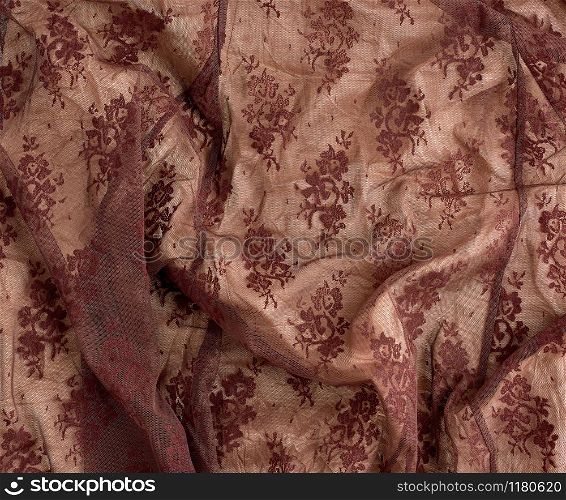 texture of crumpled brown synthetic fabric guipure for sewing clothes, full frame