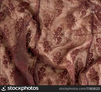 texture of crumpled brown synthetic fabric guipure for sewing clothes, full frame