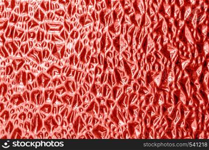 Texture of decorative glass with an abstract relief pattern colored living coral background, color of the year 2019.. Texture of decorative glass with an abstract relief pattern colored living coral background, color of the year 2019