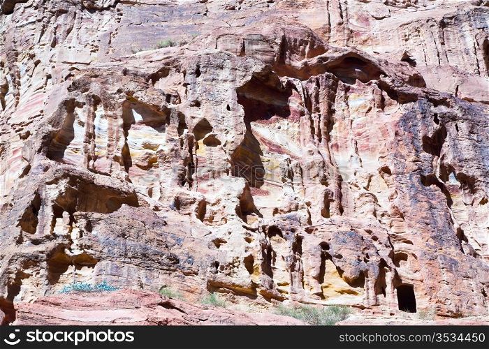 texture of eroded sandstone mountain wall in Siq, Petra