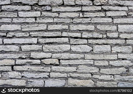 Texture of gray ancient city wall in Pskov