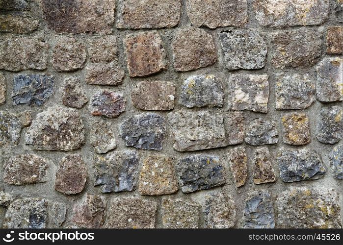 Texture of gray stone wall covered with lichen . Texture of gray stone wall covered with lichen
