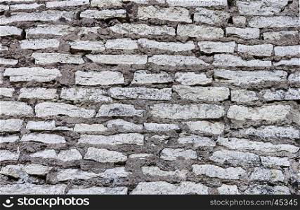 Texture of gray stone wall of ancient tower