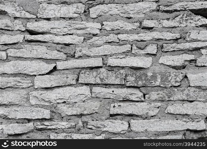 Texture of grey wall of rough flat stones