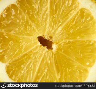 texture of half a yellow ripe lemon, full frame, close up