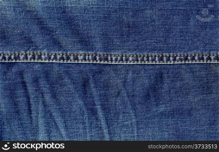 Texture of jeans cloth with a seam