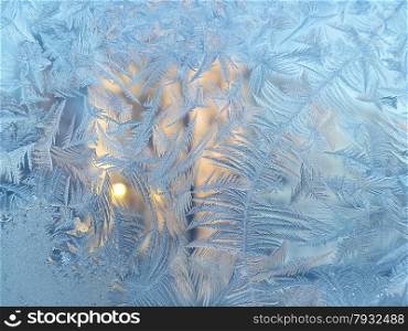 Texture of natural ice pattern and sunlight on winter glass