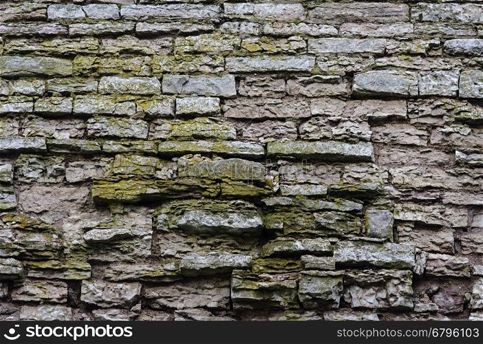 Texture of old destroyed gray stone wall