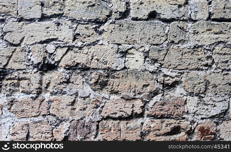 Texture of old gray scratched wall of rough bricks