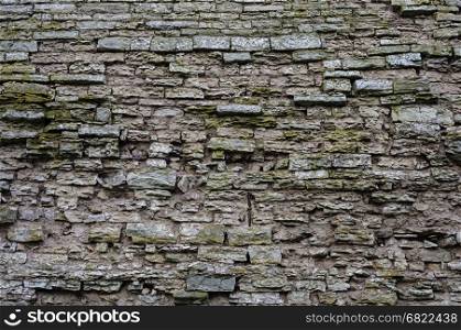 Texture of old jagged gray stone wall