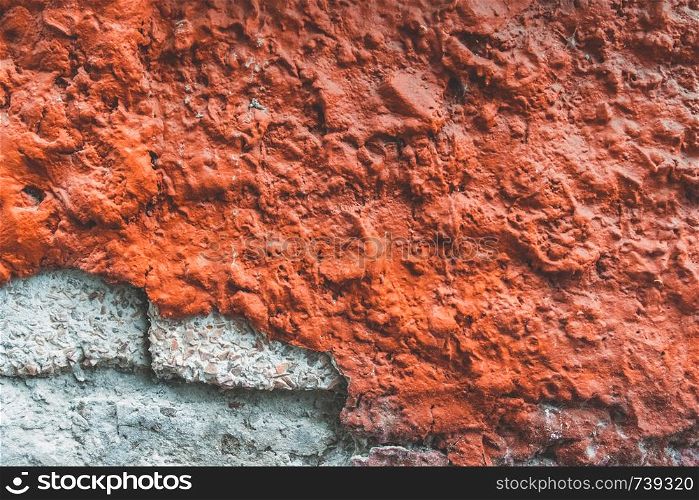Texture of old wall. Background of Wall fragment with broken stucco and bricks. Texture of old broken red wall. Background of Wall fragment with broken stucco and bricks