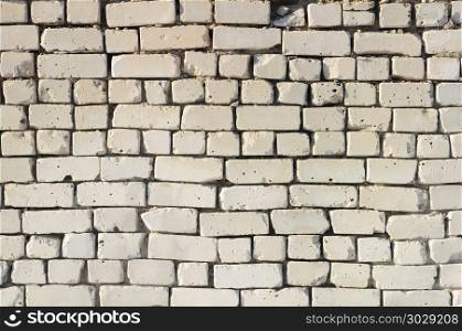 Texture of old weathered white brick wall. Old white brick wall background