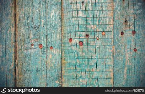 Texture of old wooden fence with rusty nails, close-up