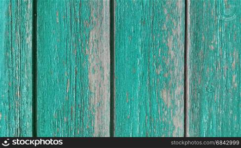 Texture of old wooden green fence close-up. Texture of old wooden green fence
