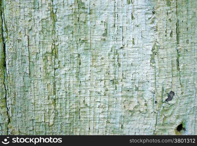 Texture of old wooden wall with a faded green flaky paint