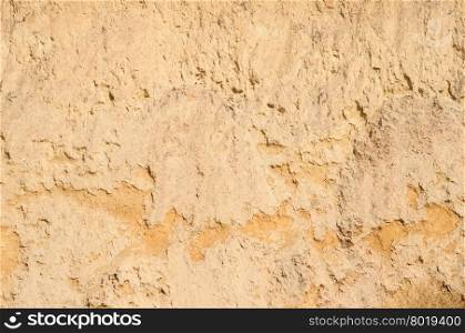 Texture of orange colored underground clay surface. The texture of clay