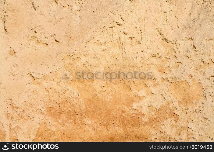 Texture of orange colored underground clay surface. The texture of clay