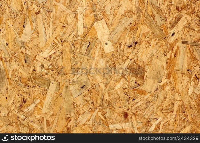 texture of oriented strand board at the exterior of an unfinished house